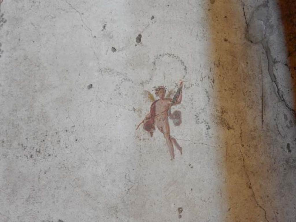 VI.15.1 Pompeii. May 2017. Painted cupid from north end of west wall.  Photo courtesy of Buzz Ferebee.

