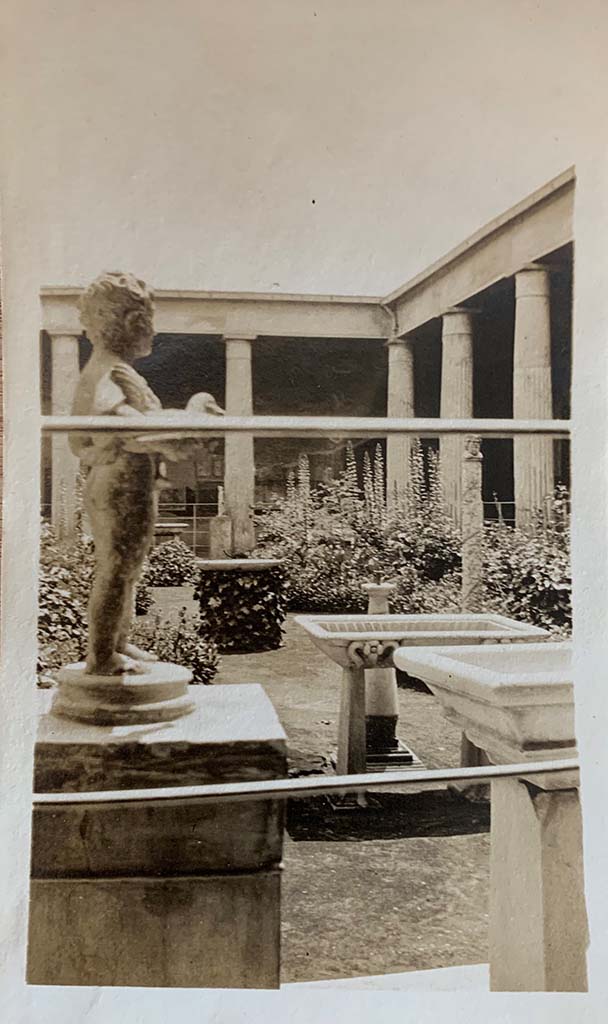 VI.15.1 Pompeii. 1907. North side of peristyle, looking south across garden area. 
Bronze garden fountain statuette of boy, bird and grapes.
Photo courtesy of Rick Bauer.
