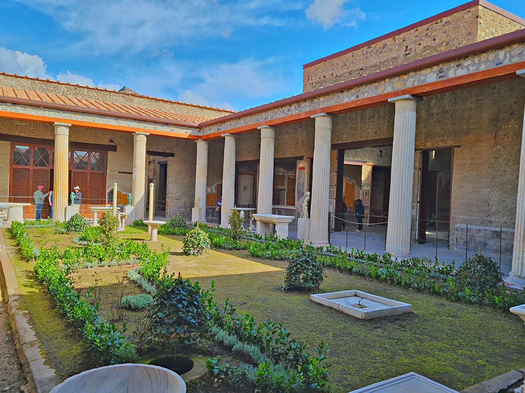 VI.15.1 Pompeii. April 2023. 
Looking north-east across peristyle towards doorway to atrium, centre right. Photo courtesy of Giuseppe Ciaramella.
