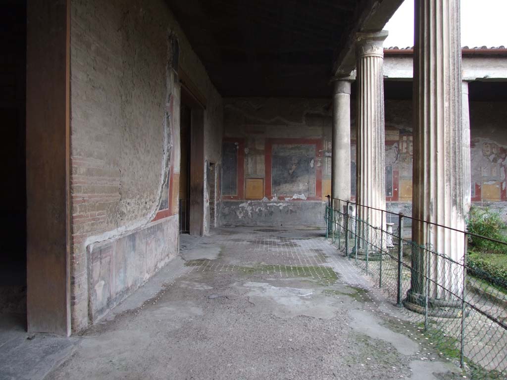 VI.15.1 Pompeii. December 2006. East side of peristyle, looking south.
The doorway on the left leads into the atrium, the next large doorway is to the Exedra in the SE of the peristyle, go to plan to view this room (PPM room - n).
