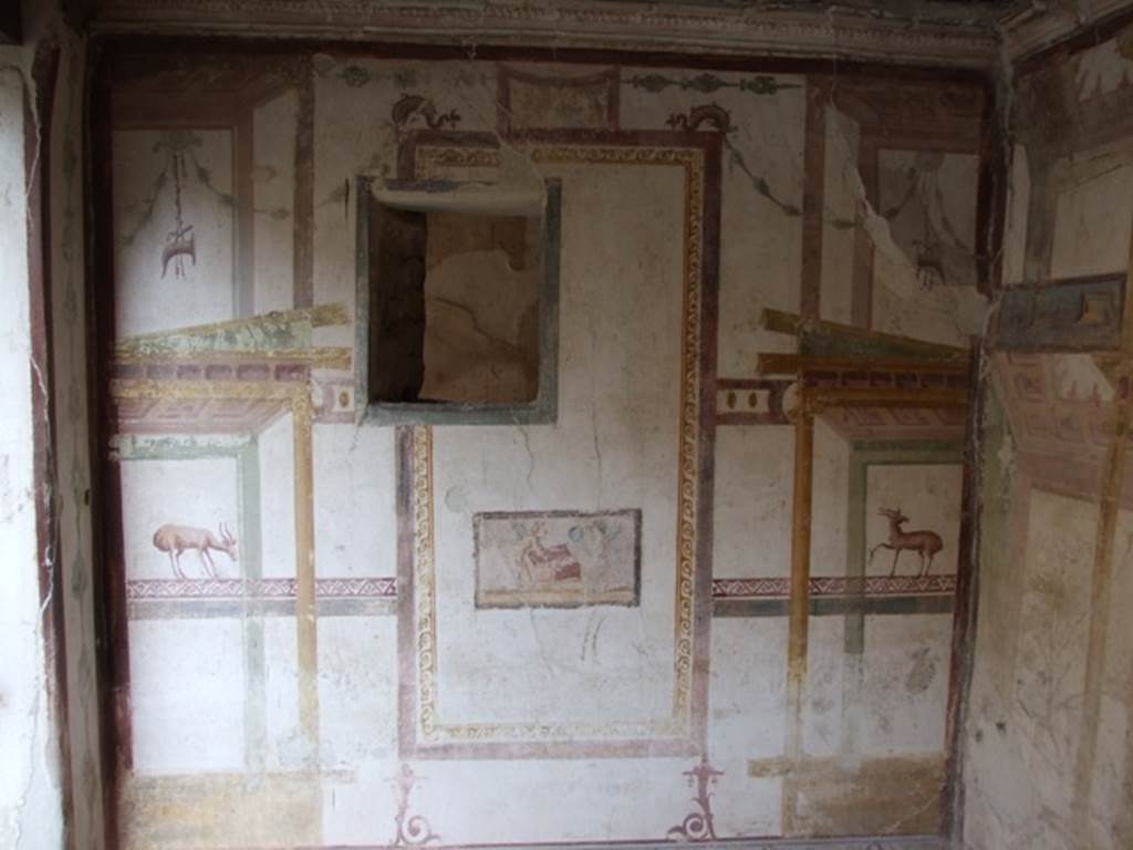 VI.15.8 Pompeii. December 2007. East wall of summer triclinium, with small window onto small recess or cupboard.   According to NdS, in the centre on the east wall was a small painting showing cupids taking objects from a small box for the toilette of Venus: the one on the right was already holding a circular mirror, the other on the left was, perhaps, taking out a jewel? See Notizie degli Scavi, January 1897, (p.38)
