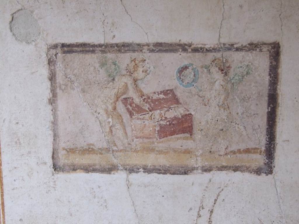 VI.15.8 Pompeii. December 2007. East wall of summer triclinium showing panel with cupids and a chest.

