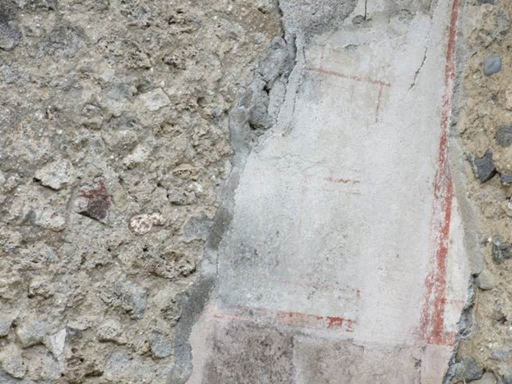 VI.16.13 Pompeii. December 2007. Remains of white and red painted plaster in north-west corner of shop.
