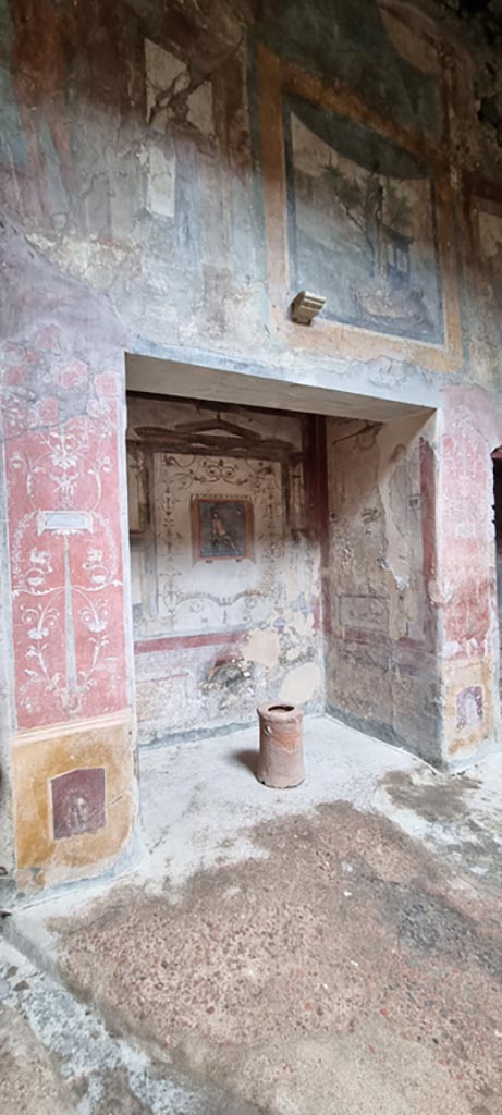 VI.16.15 Pompeii. September 2021. 
Base of painted pilaster with mask on west side of atrium with doorway to room C, on left. Photo courtesy of Klaus Heese.


