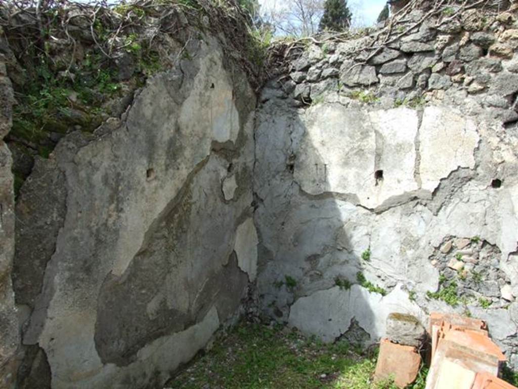 VI.16.27 Pompeii. March 2009. Room F, north-west corner of storeroom. On the north and west walls of this room, the usual square openings for the support of shelving. 
