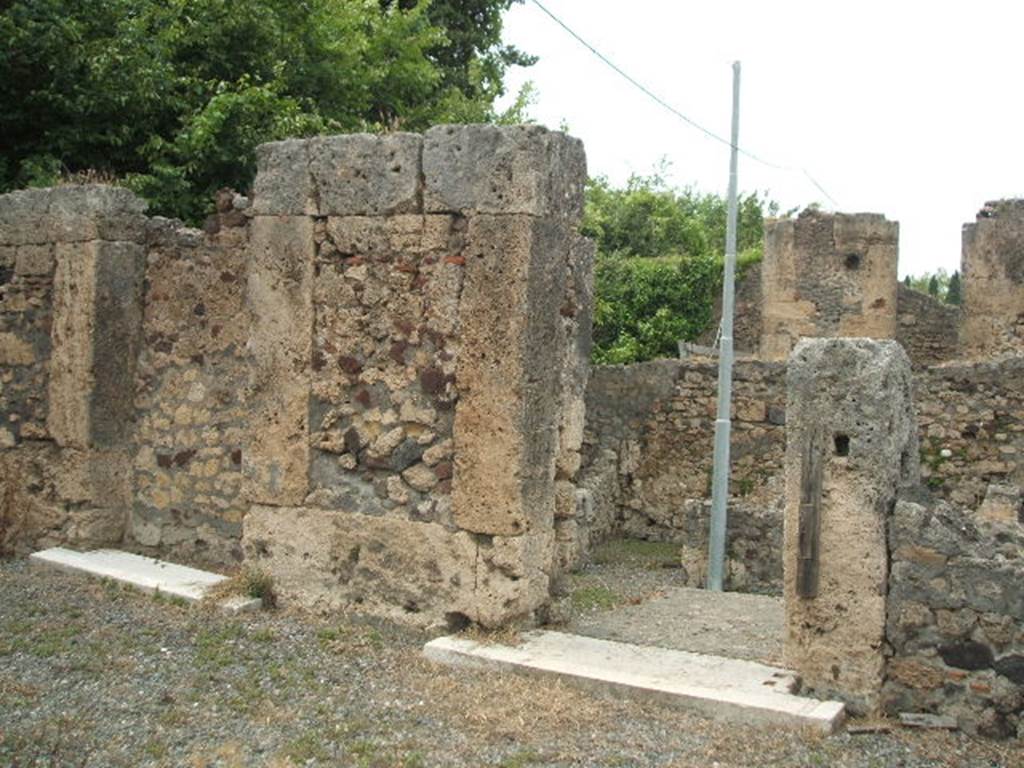 VI.17.17 Pompeii. May 2005. North wall of atrium, with doorway to steps to VI.17.16. On the left can be seen an ancient doorway, blocked.
