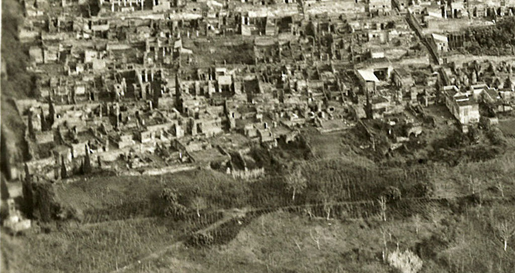 VI.17. 1  28, Insula Occidentalis, dated 9th January 1954, detail from RAF Aerial photo. Photo courtesy of Rick Bauer.
Starting from the right, the white reconstructed dwelling would be VI.17.27/8, House of the Skeletons, opposite the Vicolo di Mercurio.
On its left would be VI.17.25/26, opposite the House of Sallust, and next to that, on its left, would be the street level peristyle of VI.17.23, with a view of the remaining floors beneath, all part of the House of the Lion.
On its left, divided by a wall, front to back, would be VI.17.17/16, the House of C. Ceio.
On its left, another dividing wall would separate VI.17.13, the House of C. Nivillio
On its left would be VI.17.10/9, with some of the rear remaining floors underneath no.10, the House of the Danzatrice/of House of Diana I, opposite the House of the Surgeon.
Then there is the small house at VI.17.5, the House of Popidius Rufus
On the left of the photo is the rear of the area from VI.17.1/2/3/4. 

