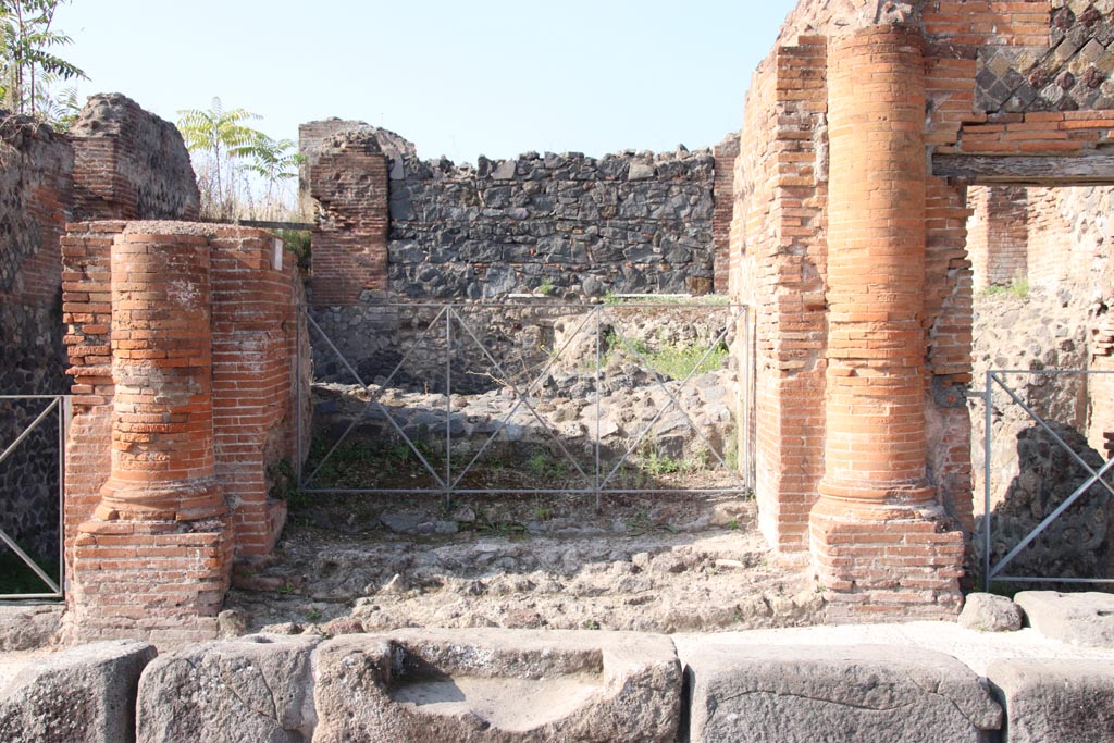 VI.17.36 Pompeii. April 2019. Looking west past step cut in kerb to entrance doorway with a brick half round column on each side. 
Photo courtesy of Rick Bauer.
According to Breton – 
“This house was built on the ancient city ramparts and had many floors on terraces leading down to the sea, it appears to have been very large but despite the excavations made in 1808 and 1817, it had never been fully excavated. Of the remains, much of it was in a large state of degradation. 
This house showed many remarkable peculiarities, having two doors onto the same street opening directly and without a prothyron onto two rooms bigger than an ordinary vestibule. The large Corinthian atrium did not have a width of less than 28.9m: its portico was formed of arches and columns.
The portico of the atrium, as well as several rooms, was paved with black and white mosaics. 
A fountain that decorated this area was not placed in the axis of the atrium, but a little to the side, in order to face the door of main vestibule.
In one of the rooms that surrounded the atrium was another small fountain. Under this house was the most beautiful cellar yet found at Pompeii.
See Breton, Ernest. (1855). Pompeia, decrite et dessine: 2nd ed. Paris: Baudry, (p.219-220)


