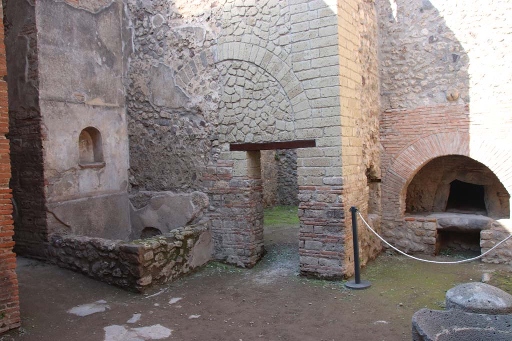 VII.1.46 Pompeii. September 2017. 
Looking north-west across kitchen 12 to niche lararium 14 built into west wall above a basin/tank.
On the left is the corridor with a small niche in its north wall. Photo courtesy of Klaus Heese.
