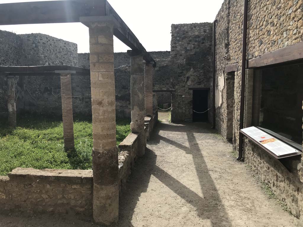VII.1.47/25 Pompeii. April 2019. 
Looking south across walled peristyle garden 19 from doorway/steps from peristyle 31 in VII.1.25. 
On the right is the window into room 8. Photo courtesy of Rick Bauer.
