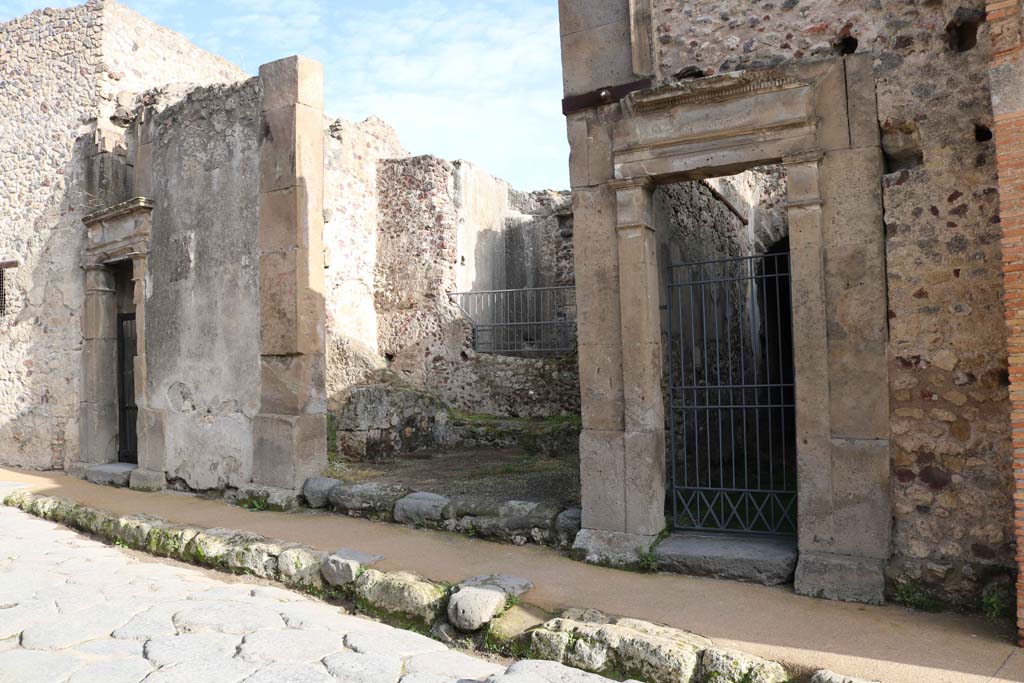 VII.1.49, Pompeii, in centre, with VII.1.48, on left, and VII.1.50, on right. December 2018. 
Looking east to entrances on Vicolo del Lupanare.  Photo courtesy of Aude Durand.
