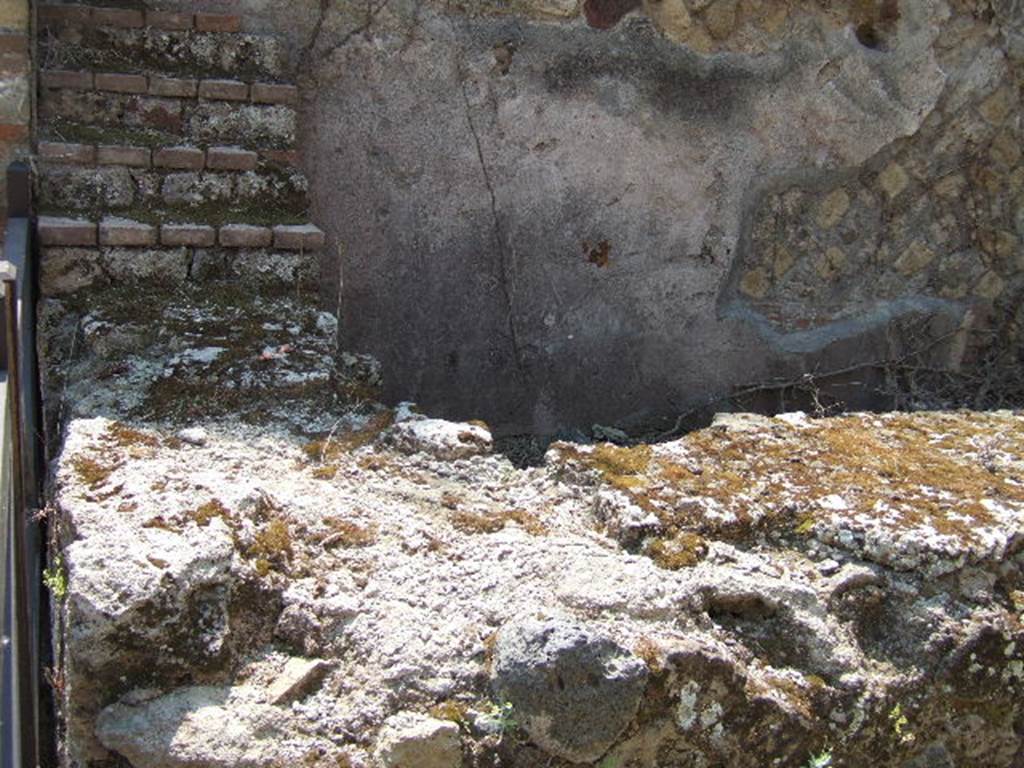 VII.2.15 Pompeii. May 2006. Counter, with display shelving against the south wall. 