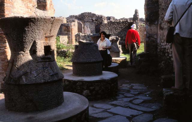 VII.2.22 Pompeii. July 1980. Looking east across mills in bakery. 
Photo courtesy of Rick Bauer, from Dr George Fay’s slides collection.
