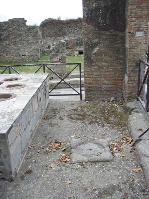 VII.2.32 Pompeii. May 2003. Looking south on west side of bar-room, near entrance at VII.2.32, looking towards VII.2.33 on Via degli Augustali. Photo courtesy of Nicolas Monteix.
