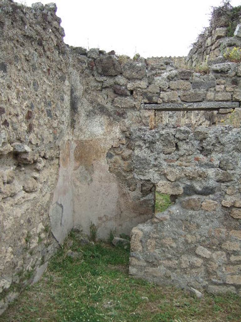VII.2.39 Pompeii. May 2006. Doorway to latrine in north-west corner of shop.
