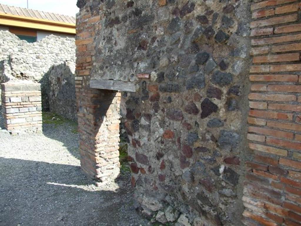 VII.4.4  Pompeii. March 2009. South wall of thermopolium, with doorway to cupboard or small room, under stairs of entrance VII.4.5