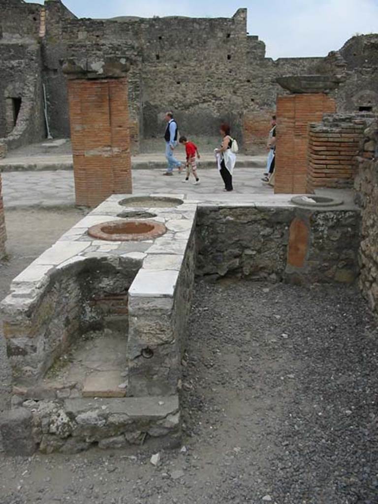 VII.4.4 Pompeii. May 2003.  Looking west towards Via del Foro, from rear of counter with hearth on its eastern end. Photo courtesy of Nicolas Monteix.
