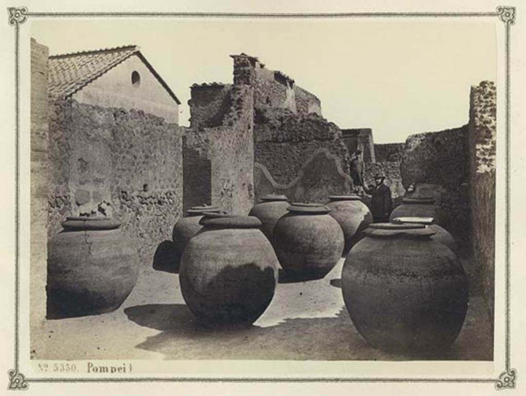VII.4.13 Pompeii. Album dated January 1874. Looking east towards shop with large dolia. Photo courtesy of Rick Bauer.
