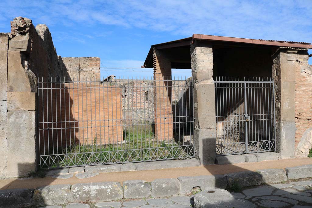 VII.4.24 Pompeii, on left. December 2018. Looking north on Via degli Augustali. Photo courtesy of Aude Durand.