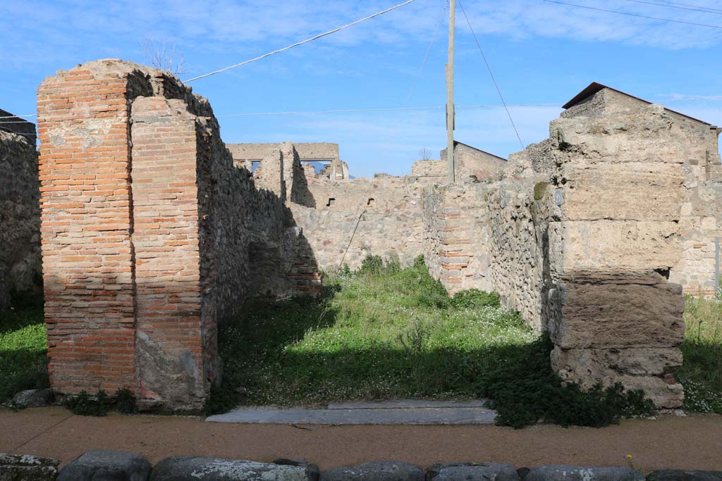 VII.4.28 Pompeii. December 2018. 
Looking north towards entrance doorway to shop-room, and rear room. Photo courtesy of Aude Durand.
According to Fiorelli, this shop had a rear room containing a hearth, latrine and against the rear wall was a staircase to upper floor.
See Pappalardo, U., 2001. La Descrizione di Pompei per Giuseppe Fiorelli (1875). Napoli: Massa Editore. (p.90).
