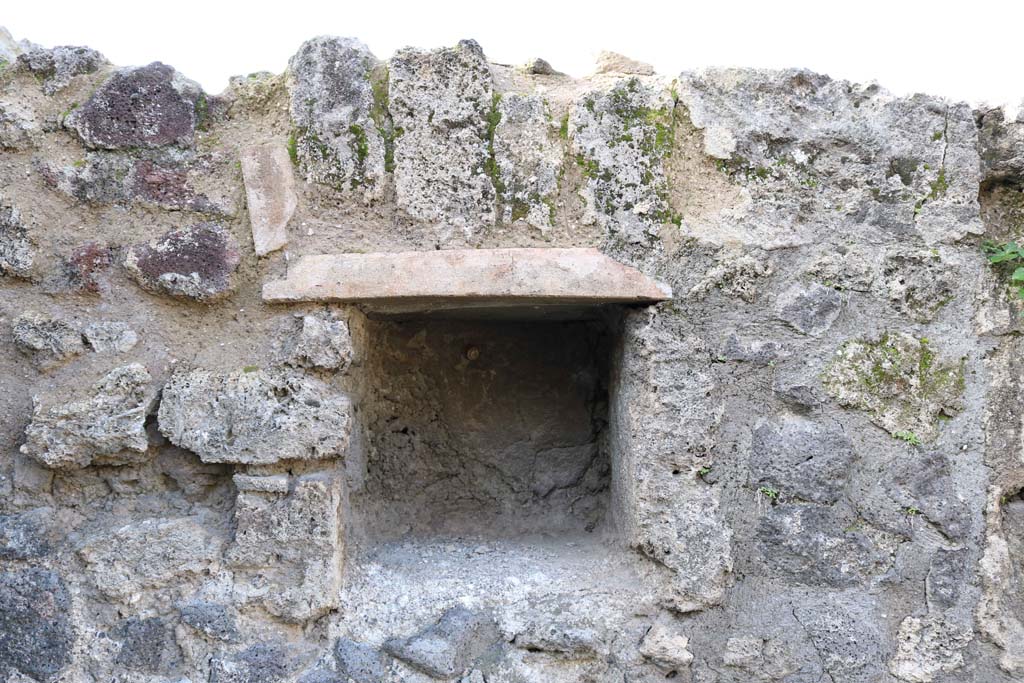 VII.4.52, Pompeii, December 2018. Looking towards square niche set into west wall of shop. Photo courtesy of Aude Durand.