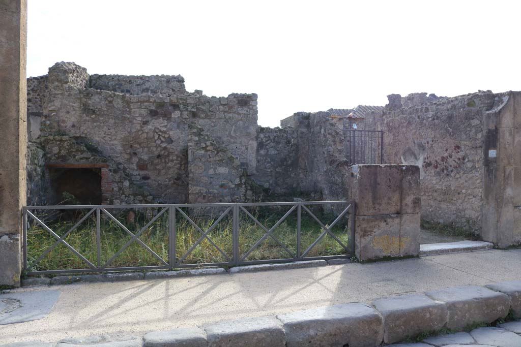 VII.4.58 Pompeii. December 2018. Looking south towards rear wall with two staircases. Photo courtesy of Aude Durand.
According to Avellino
“Si entra in questa per la maggiore delle additate aperture, la cui soglia era di marmo………
Il pavimento è di mattoni pesti: e rosso è l’intonaco. 
Sul lato di fronte di questa bottega trovansi diversi gradini di una doppia scaletta di fabbrica. La prima di esse piega a sinistra, comincia dal livello del suolo, e se ne conservano nove scalini che lasciano sotto di essi una cavita. L’altra che segue piega pure a sinistra e dopo tre scalini ha un riposo, dal quale di fronte si ha il passaggio e la discesa nell’atrio, ed incomincia pur la scala a piegare a sinistra essendone conservati sette scalini. E quindi evidente che questa due scalette conducevano a diversi siti: e la loro disposizione ne fa sospettare che la prima conducesse ad una qualche divisione che diremmo ammezzato (contignatio, tabulatum) e la seconda al piano superiore dell’edificio.

Nel corpo del muro esterno di questa bottega, e propriamente nell’angolo che fa colla casa che le e a sinistra, veggonsi i tubi di creta che congiunti tra loro formano il condotto di un cesso o luogo immondo, la cui apertura era situata nel piano superiore.”

(“One enters into this shop by the largest of the openings, whose threshold was of marble..…….
The floor was of mattoni pesti (brick paste): and the plaster was red.  
On the opposite side of this shop several steps of a double masonry staircase were found. The first of them leads to the left, starting at ground level, and there are nine steps that leave a recess/opening below them. The other that follows also leads to the left and after three steps has a landing/rest, from which facing you, you have the passage and descent into the atrium, and begins the staircase leading to the left with seven steps being preserved. It is therefore evident that these two staircases led to different sites: and their arrangement makes us suspect that the first led to an area that we would call “mezzanine” (rafters, flooring) and the second to the upper floor of the building.

In the body of the outer wall, and really in the corner of this shop, and properly in the corner that is part of the house that it is on the left of, we see the clay pipes that joined together to form the conduit of a toilet or unclean place, whose opening was located in the upper floor.”)
See Avellino, F.M. Descrizione di una casa disotterrata in Pompei negli anni 1832, 1833 e 1834, la seconda alle spalle del tempio di Fortuna Augusta. (p.5-8)
