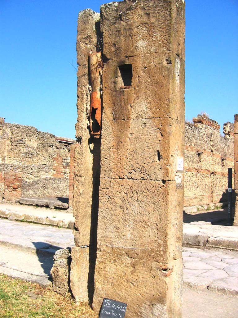 VII.4.60/61 Pompeii. July 2008. 
Looking north to rear of pilaster with downpipe, between VII.4.60 and VII.4.61. 
Photo courtesy of Barry Hobson.
