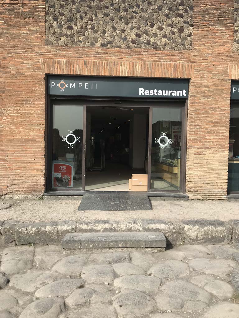 VII.5.19 Pompeii. April 2019. Looking west to entrance to modern restaurant on Via del Foro. 
Photo courtesy of Rick Bauer.
