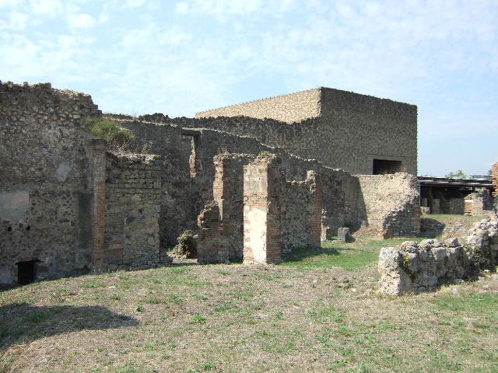 VII.6.3 Pompeii. Looking north-west from room 18 to tablinum 12, corridors 17 and 15 and rooms 10 and 7. The position of the temple Lararium shrine is approximately to the rear of where the large shadow is shown on the left. This area was devastated in the 1943 bombing.