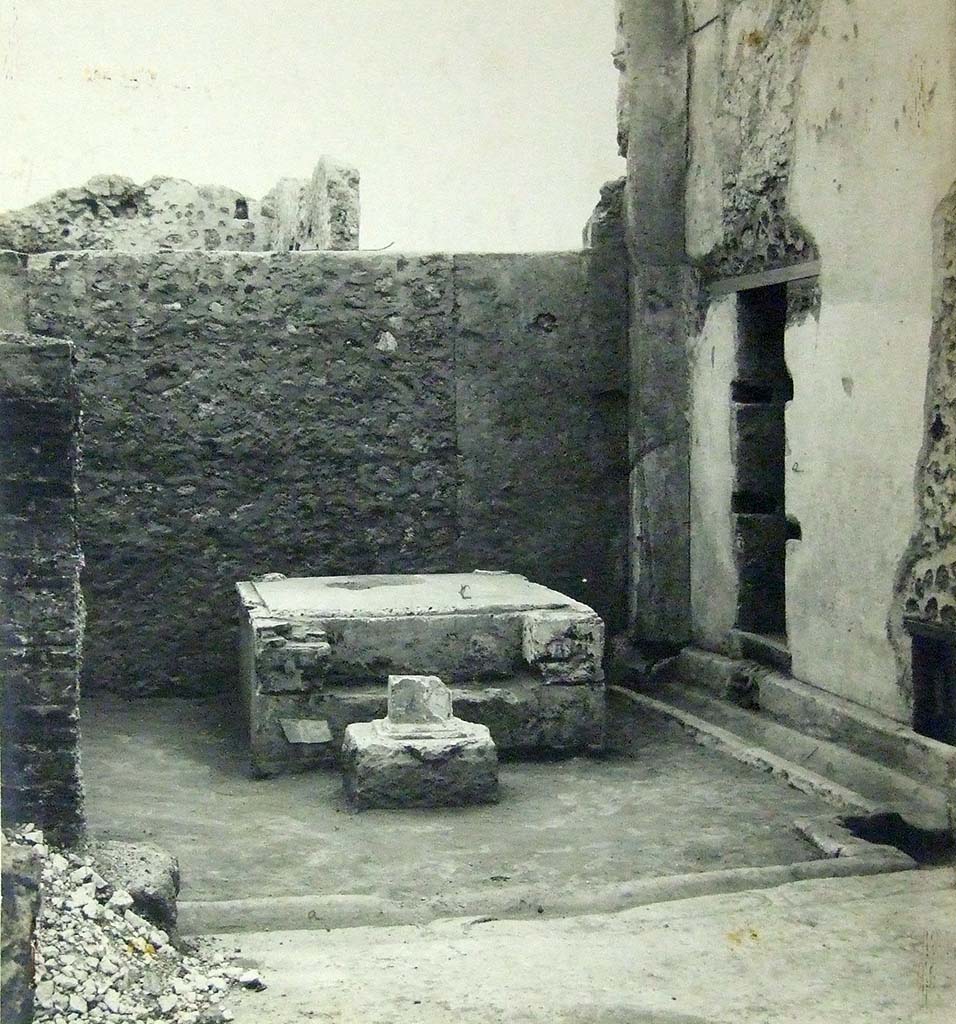 VII.6.3 Pompeii. 1910. Room 18, viridarium in south-west corner of the peristyle. 
Base of a Temple Lararium shrine (r) with a small altar in front.
According to Jashemski, 
“Professor Richardson has shown that the well-known archaic statue of Diana, (Mus. Naz. Inv. No. 6008) which was found at Pompeii in 1760, came from the large and elegant shrine in the south-west part of the garden. There was a tufa altar in front of the shrine”.
See Jashemski, W. F., 1993. The Gardens of Pompeii, Volume II: Appendices. New York: Caratzas. (p.184).
Photograph courtesy of Soprintendenza Speciale per i Beni Archeologici di Napoli e Pompei.
