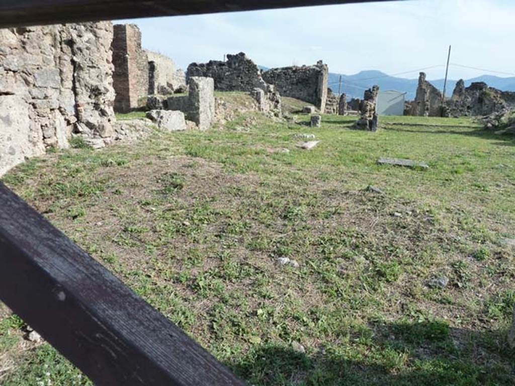 VII.6.8 Pompeii. September 2015.  In the foreground behind the wooden gate, would have been the site of the shop at VII.6.8.  In the background behind the shop would have been the house at VII.6.7.
