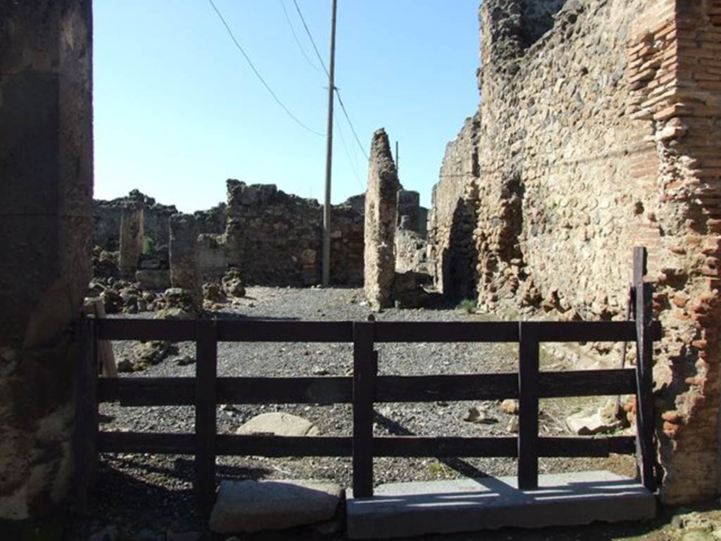 VII.6.19 Pompeii. March 2009. Looking west across workshop to rear.
According to Garcia y Garcia, this was very devastated and ruined following the September 1943 bombing, together with VII.6.20.
See Garcia y Garcia, L., 2006. Danni di guerra a Pompei. Rome: L’Erma di Bretschneider. (p.102). 
According to Della Corte, because of the considerable quantities of colouring materials and pigments found here, he considered it the workshop of an unknown and unnamed Negotiator Pigmentarius.
See Della Corte, M., 1965.  Case ed Abitanti di Pompei. Napoli: Fausto Fiorentino. (p.173)
