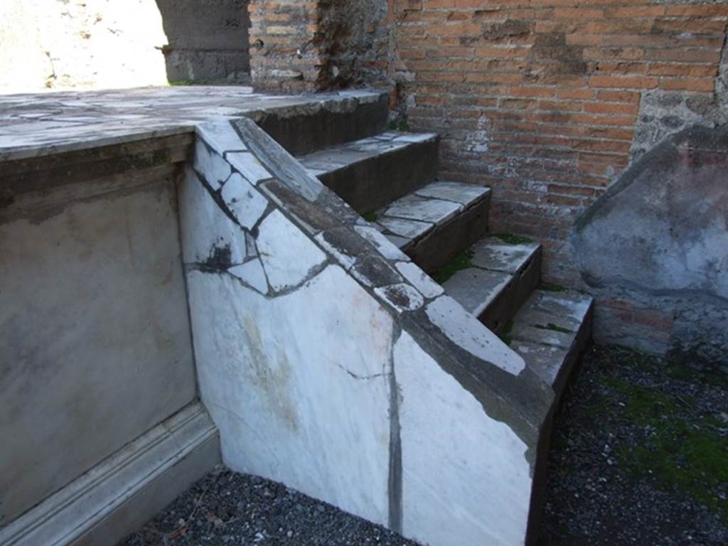 VII.9.7 and VII.9.8 Pompeii. Macellum. March 2009. Steps to marble podium.