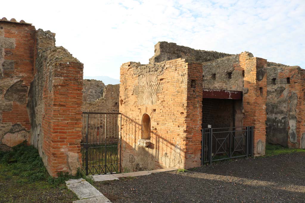 VII.9.7 and VII.9.8 Pompeii. Macellum. December 2018. 
Looking towards south entrance of Macellum, with altar, looking down steps to Vicolo del Balcone Pensile, at VII.9.42.
Photo courtesy of Aude Durand. 

