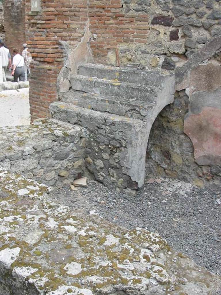 VII.9.30 Pompeii. May 2003. Shelving for display of crockery, with recess below, at east end of counter. Photo courtesy of Nicolas Monteix.

