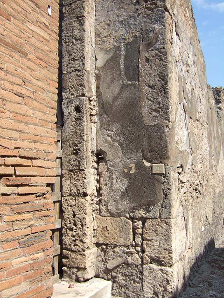 VII.15.2 Pompeii. September 2005. Wall on east side of entrance.