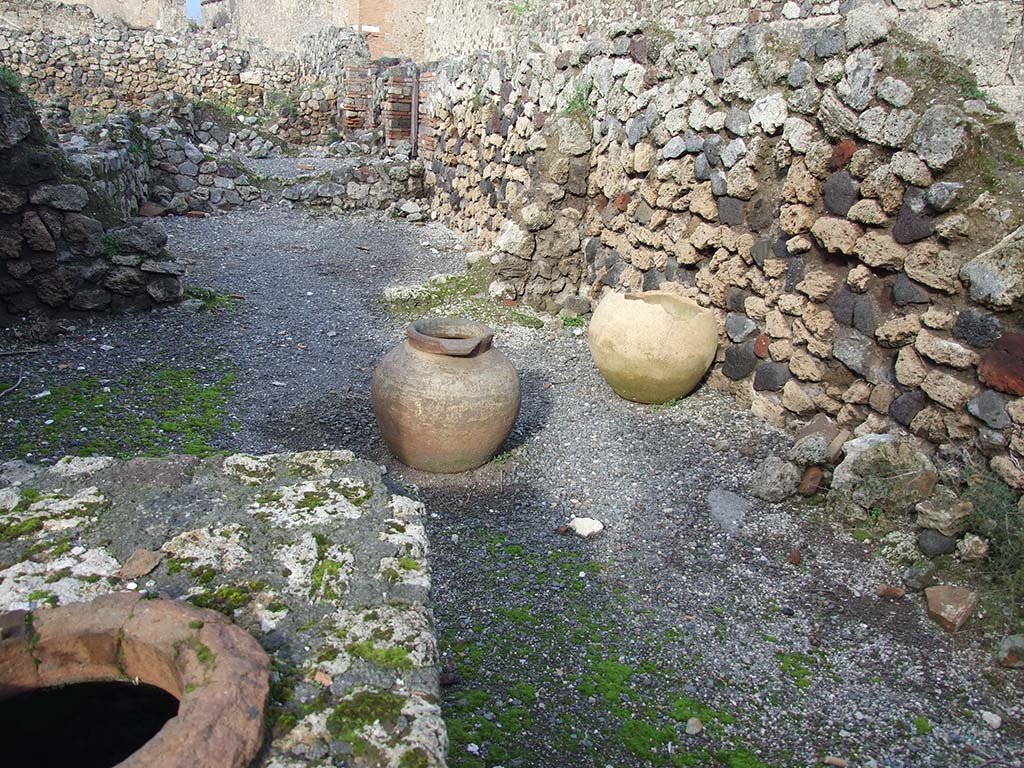 VII.16.7 Pompeii. December 2006.  Looking north towards rear room and two dolia.
According to Garcia y Garcia, the thermopolium linked with VII.16.8 was destroyed by the 1943 bombing, then badly restored.
It deleted the doorway that was between the two properties.
See Garcia y Garcia, L., 2006. Danni di guerra a Pompei. Rome: L’Erma di Bretschneider. (p.131).
