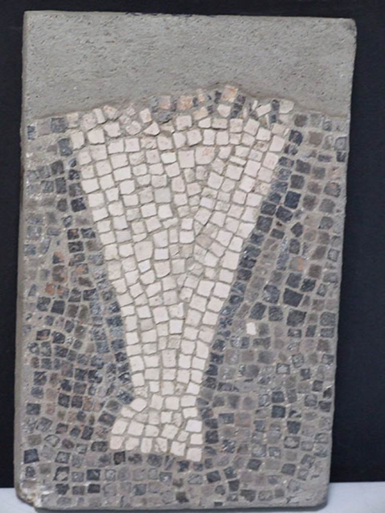 VII.16.15 Pompeii.  March 2009. Room 2, atrium from corner of Impluvium. 
Detail of part of mosaic showing garum amphora with illegible inscription.
According to Esposito the fourth mosaic was incomplete at the time of the excavation and the inscription was illegible.
SAP inventory number 15191.
See Esposito in Aoyagi M. and Pappalardo U., 2006. Pompei (Regiones VI-VII) Insula Occidentalis. Napoli: Valtrend. (P. 511).
