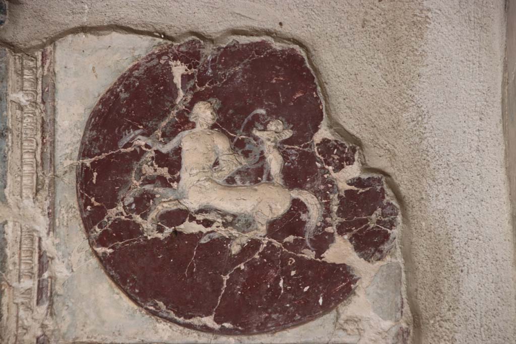 VII.16.a Pompeii. October 2020. Room 1, plasterwork and painting with centaur and cupid on medallion on east side of north wall. 
Photo courtesy of Klaus Heese.
