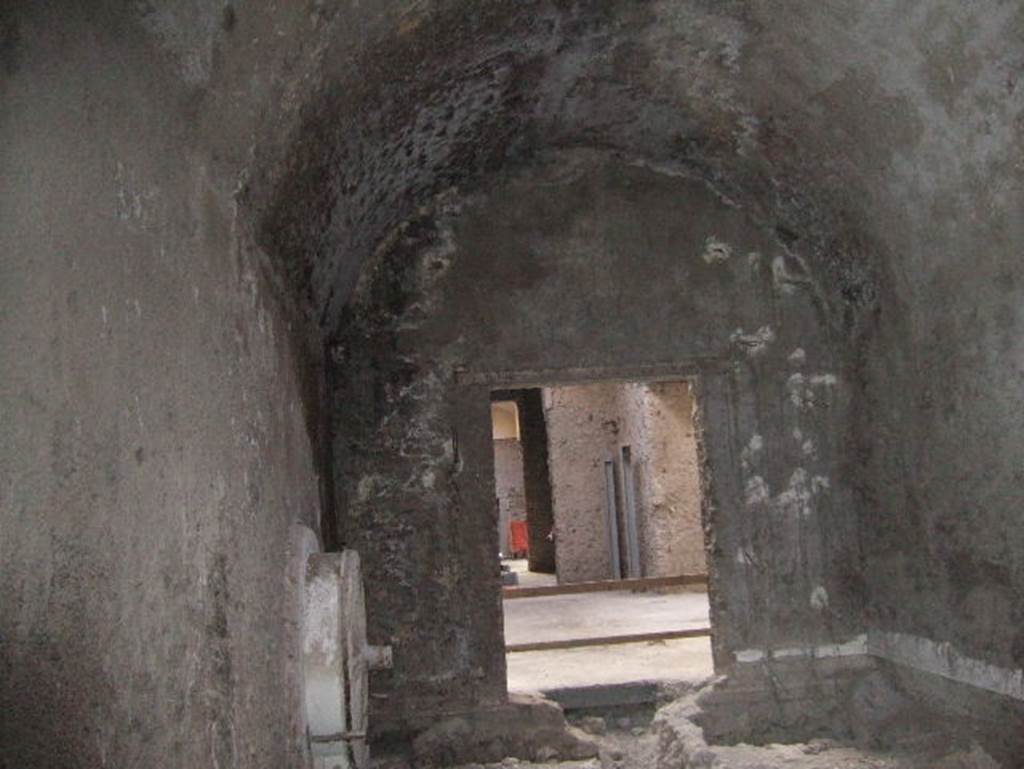 VIII.1.4 Pompeii Antiquarium. December 2005. Exit room with cast of a wheel on left.
In this room were also displayed the casts of a tree, a cupboard, and the crouching man found in the Palaestra.
The wheel, fixed to the wall, was the only item that remained after the 1978 closure and relocation of items.
