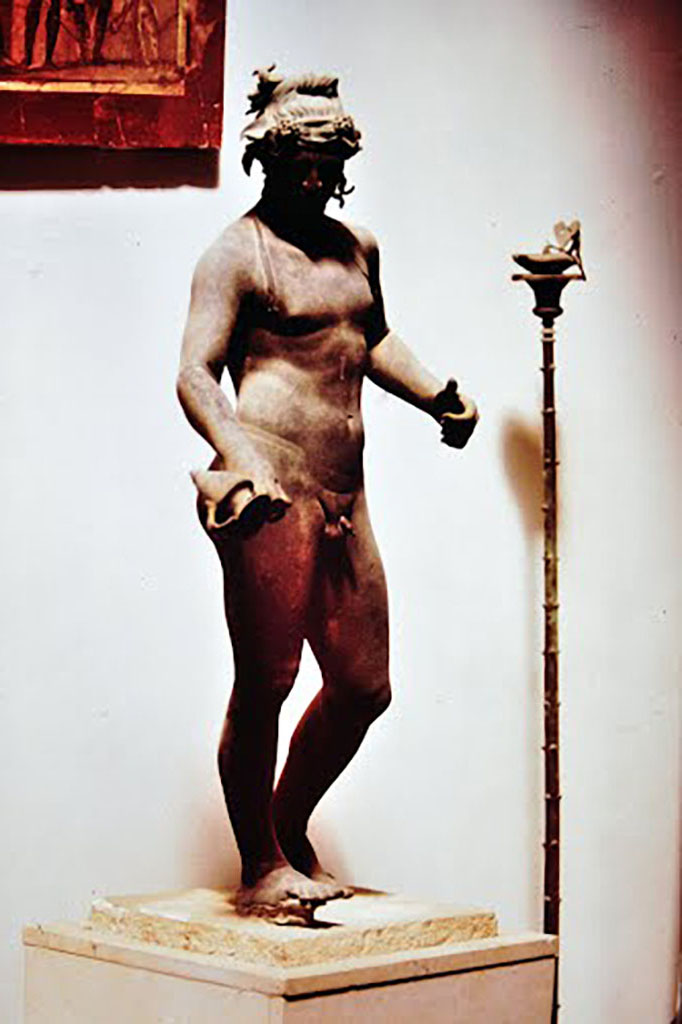 VIII.1.4 Pompeii Antiquarium. 1970. Bronze male statue and candelabra.