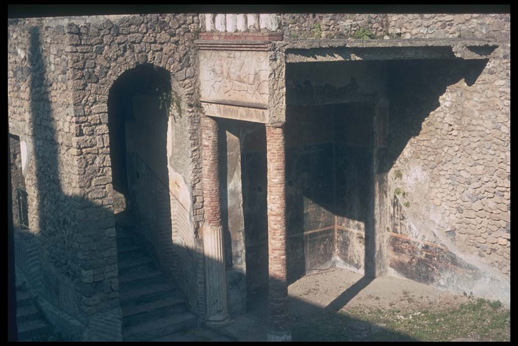 VIII.1.a Pompeii. December 2007. North end of portico. Painted plaster and steps from garden.