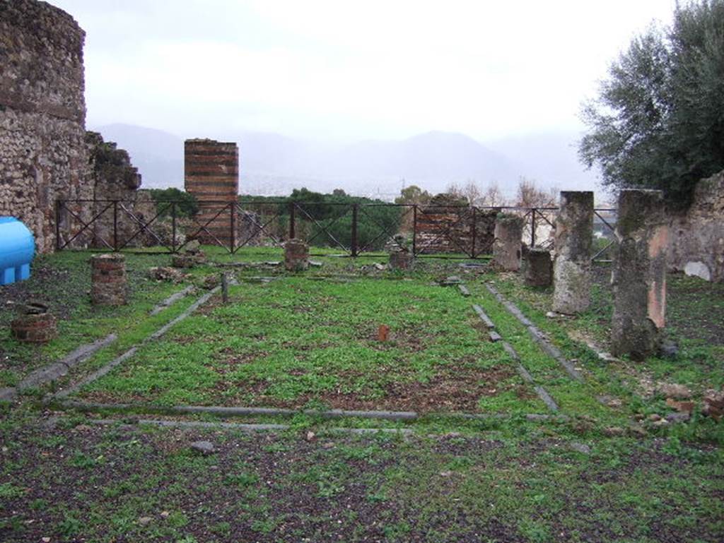 VIII.2.3 Pompeii. December 2005. Looking south across peristyle garden.
According to Jashemski, this peristyle garden, was enclosed on four sides by a portico supported by fourteen columns.  Off the north-west corner of the peristyle was a small room which Mazois and Fiorelli call a sacrarium. 
At the rear, there was a terrace. See Jashemski, W. F., 1993. The Gardens of Pompeii, Volume II: Appendices. New York: Caratzas. (p.205)
