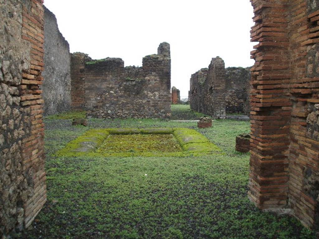 VIII.2.14 Pompeii. December 2004.  Looking across atrium towards rooms at rear, from entrance corridor. According to Jashemski, at the rear was a large peristyle garden, linked to VIII.2.16 by a room, opening on both ends to a different peristyle. This garden was laid out on a volcanic ledge, and was enclosed on four sides by a portico supported by fourteen columns. There was a rectangular pool in the south-east corner of the peristyle, which had amphorae in it. These would have served as a shady retreat for fish. See Jashemski, W. F., 1993. The Gardens of Pompeii, Volume II: Appendices. New York: Caratzas. (p.205)
