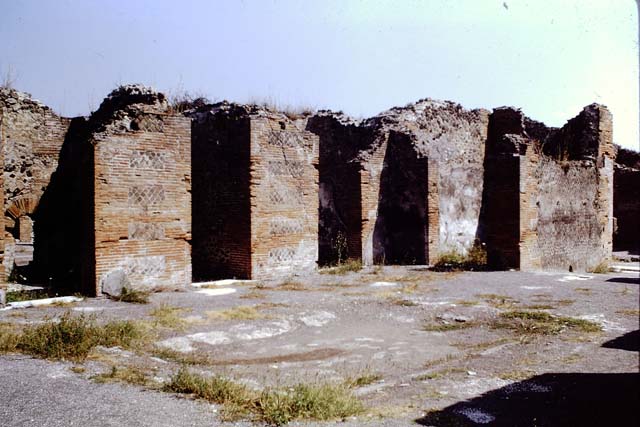 VIII.2.16 Pompeii. September 2005. Doorways on north side of atrium, the central one leading to VIII.2.14, on the left of it is a cubiculum with windowed niche, and on the right of it is another cubiculum.  
