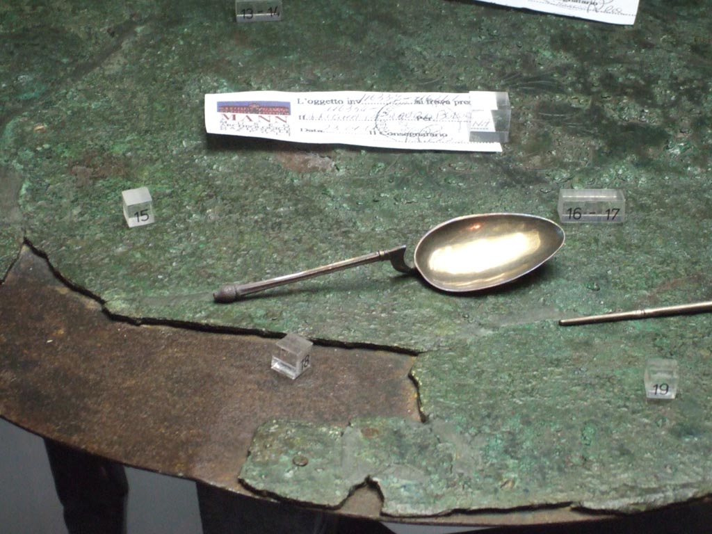 Silver spoon of type ligula found 20th September 1887 in VIII.2.23.  
Now in Naples Archaeological Museum. Inventory number 25416.
