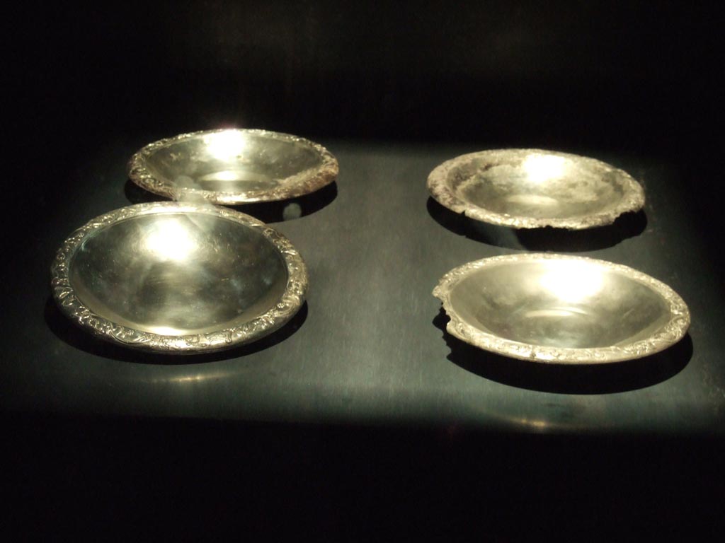 Four silver plates found 20th September 1887 in VIII.2.23. 
Now in Naples Archaeological Museum.  Inventory numbers 116345, 116346, 116347 and 116348. 
See Guzzo, P. (A cura di), 2006. Argenti a Pompei. Milano, Electa. (pp. 130-4).
