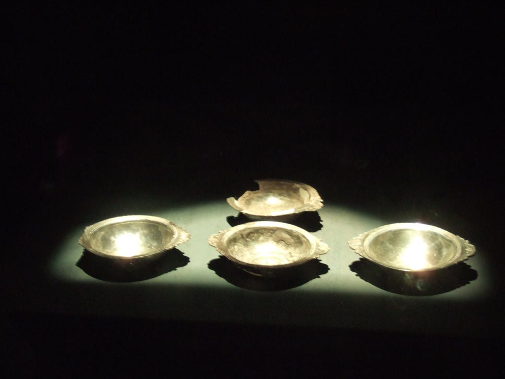 Four silver plates found 20th September 1887 in VIII.2.23. 
Now in Naples Archaeological Museum.  Inventory numbers 116341, 116342, 116343 and 116344.
See Guzzo, P. (A cura di), 2006. Argenti a Pompei. Milano, Electa. (p. 133).
