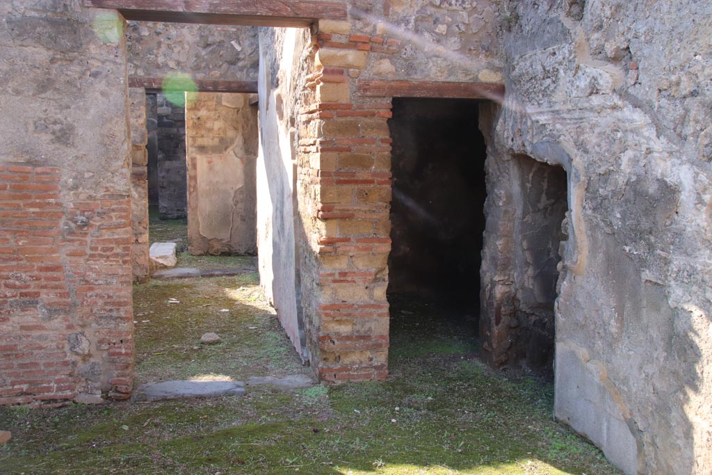 VIII.3.11 Pompeii. October 2022. 
South-west corner, with doorway leading to VIII.3.12, centre left, and to a cubiculum and storeroom, on right. Photo courtesy of Klaus Heese. 


