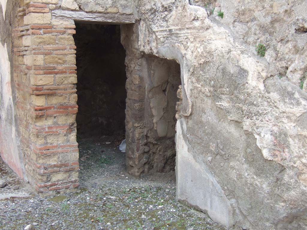 VIII.3.11 Pompeii. May 2006. South-west corner, with two doorways, one into a cubiculum, the other into a storeroom.
The cubiculum would have had white painted walls separated into panels by red lines.
